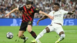 Ruben Dias of Manchester City is challenged by Vinicius Junior of Real Madrid