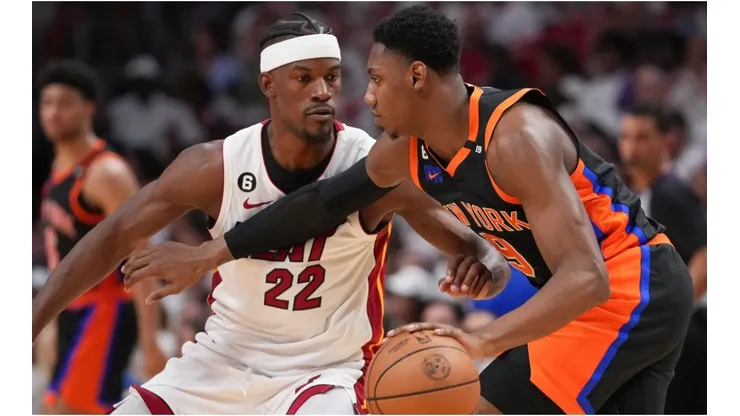RJ Barrett #9 of the New York Knicks dribbles upcourt while being defended by Jimmy Butler #22 of the Miami Heat