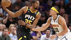 Kevin Durant #35 of the Phoenix Suns handles the ball against Aaron Gordon #50 of the Denver Nuggets