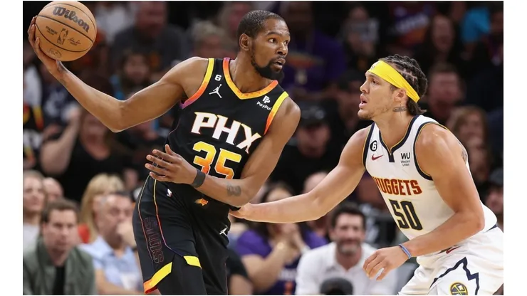 Kevin Durant #35 of the Phoenix Suns handles the ball against Aaron Gordon #50 of the Denver Nuggets