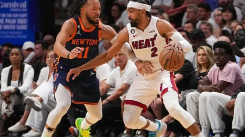 Gabe Vincent #2 of the Miami Heat dribbles the basketball while being defended by Jalen Brunson #11 of the New York Knicks