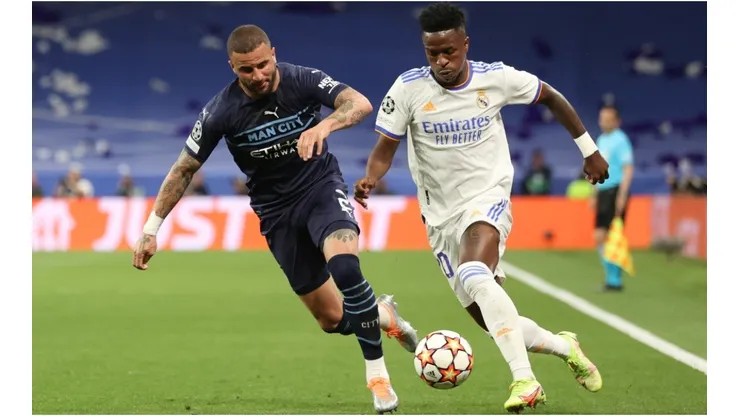 Vinicius Junior (R) of Real Madrid CF competes for the ball with Kyle Walker (L) of Manchester City FC