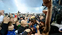 Victor Osimhen of SSC Napoli is surrounded by SSC Napoli fans who celebrate the Serie A title.