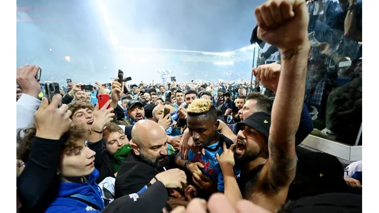 Victor Osimhen of SSC Napoli is surrounded by SSC Napoli fans who celebrate the Serie A title.