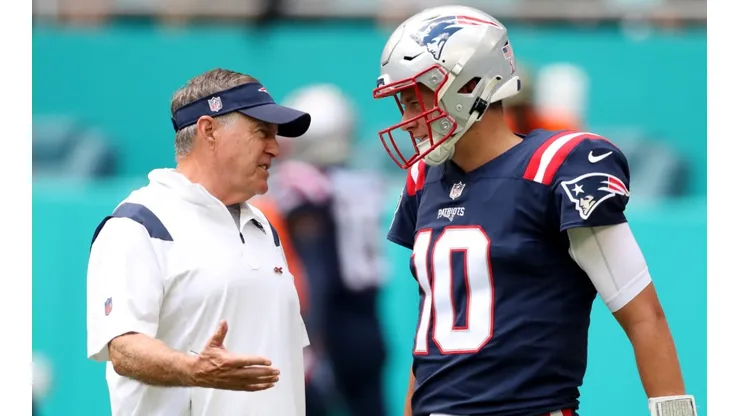 Bill Belichick (left) talking with Mac Jones - New England Patriots - NFL 2022