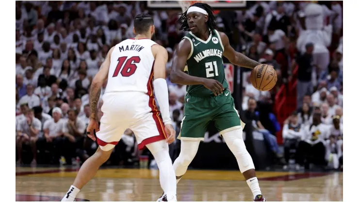 Jrue Holiday #21 of the Milwaukee Bucks controls the ball against Caleb Martin #16 of the Miami Heat