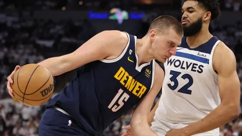 Nikola Jokic #15 of the Denver Nuggets drives the ball against Karl-Anthony Towns #32 of the Minnesota Timberwolves
