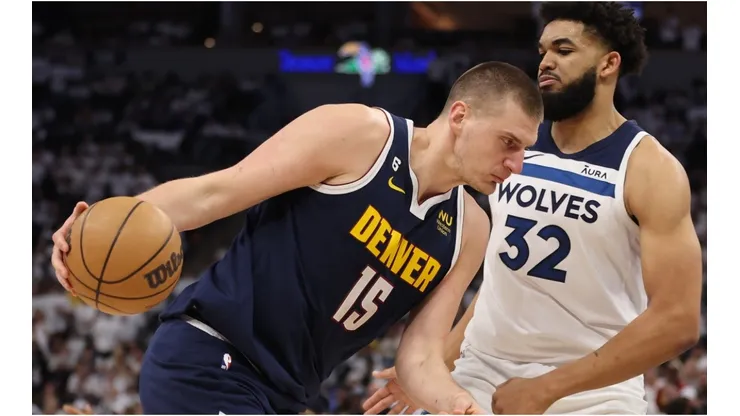 Nikola Jokic #15 of the Denver Nuggets drives the ball against Karl-Anthony Towns #32 of the Minnesota Timberwolves