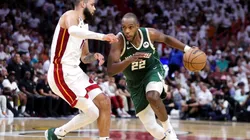 Khris Middleton #22 of the Milwaukee Bucks dribbles the ball against Caleb Martin #16 of the Miami Heat