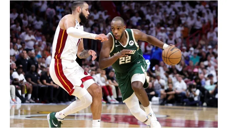 Khris Middleton #22 of the Milwaukee Bucks dribbles the ball against Caleb Martin #16 of the Miami Heat