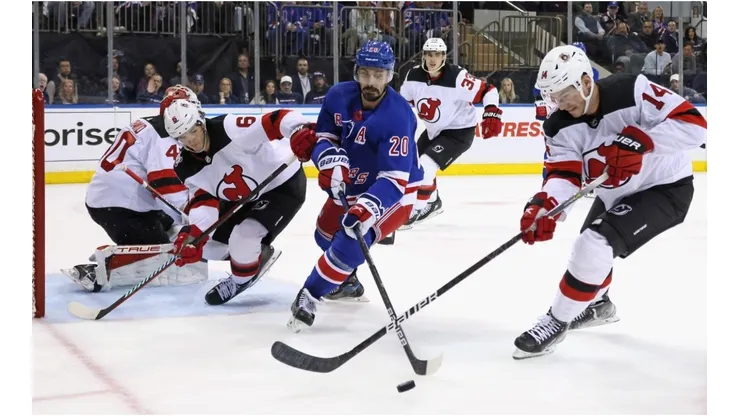 Chris Kreider #20 of the New York Rangers and Nathan Bastian #14 of the New Jersey Devils battle for the puck