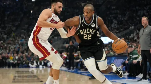 Khris Middleton #22 of the Milwaukee Bucks dribbles the ball against Max Strus #31 of the Miami Heat