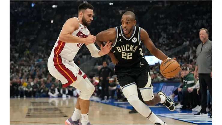 Khris Middleton #22 of the Milwaukee Bucks dribbles the ball against Max Strus #31 of the Miami Heat