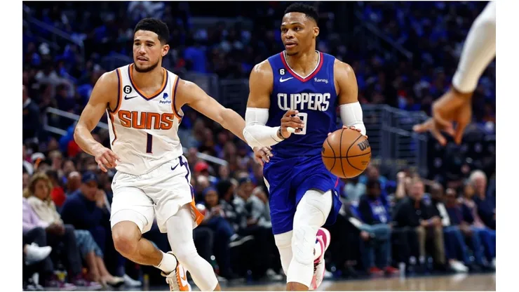 Russell Westbrook #0 of the LA Clippers controls the ball against Devin Booker #1 of the Phoenix Suns