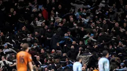 Manchester City fans turn their back on the pitch following a goal.