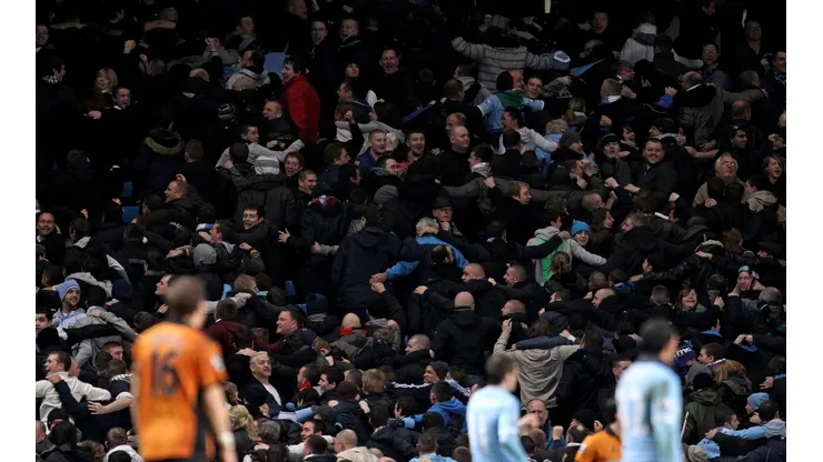 Manchester City fans turn their back on the pitch following a goal.