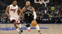 Jevon Carter #5 of the Milwaukee Bucks drives around Kyle Lowry #7 of the Miami Heat