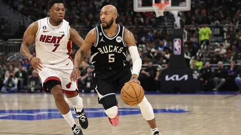 Jevon Carter #5 of the Milwaukee Bucks drives around Kyle Lowry #7 of the Miami Heat