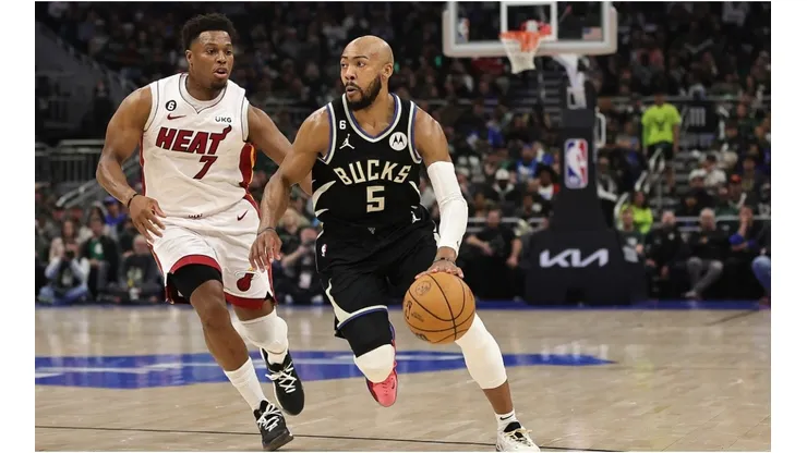 Jevon Carter #5 of the Milwaukee Bucks drives around Kyle Lowry #7 of the Miami Heat