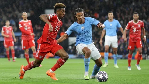 Nathan Ake of Manchester City is put under pressure by Kingsley Coman of FC Bayern Munich