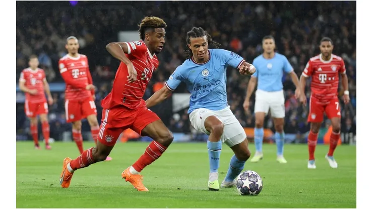 Nathan Ake of Manchester City is put under pressure by Kingsley Coman of FC Bayern Munich