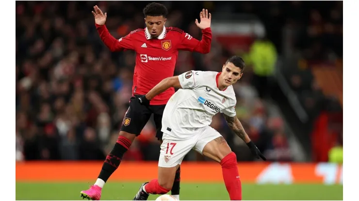 Erik Lamela of Sevilla FC is put under pressure by Jadon Sancho of Manchester United