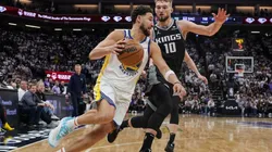 Klay Thompson #11 of the Golden State Warriors drives to the basket as Domantas Sabonis #10 of the Sacramento Kings defends