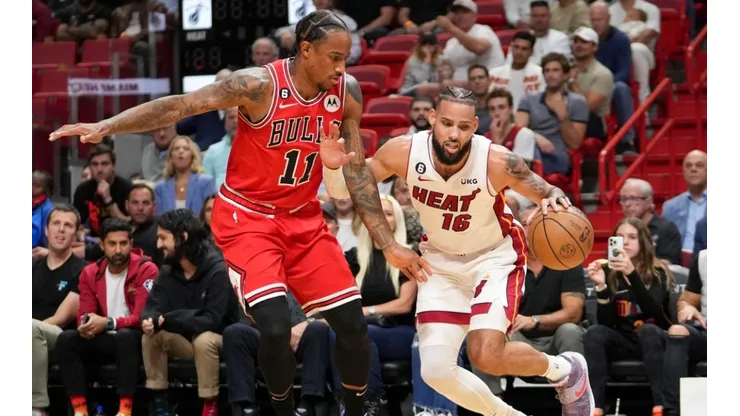 Caleb Martin #16 of the Miami Heat drives past DeMar DeRozan #11 of the Chicago Bulls.