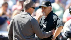 Umpire Larry Vanover being checked out by a trainer after getting hit in the Yankees-Guardians game.