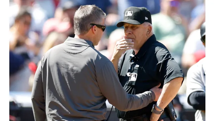 Umpire Larry Vanover being checked out by a trainer after getting hit in the Yankees-Guardians game.
