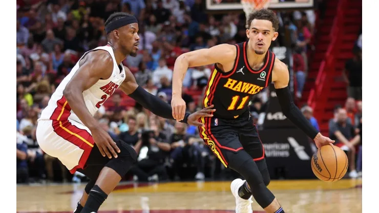 Trae Young dribbles against Jimmy Butler.