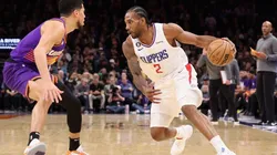 Kawhi Leonard #2 of the LA Clippers handles the ball against Devin Booker #1 of the Phoenix Suns