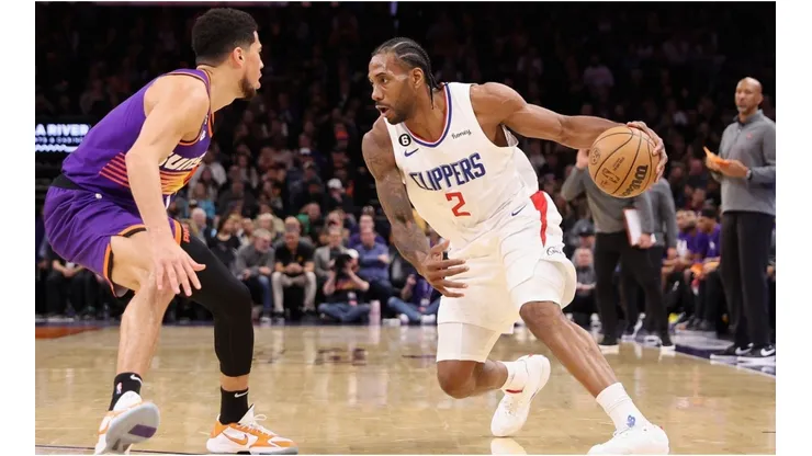 Kawhi Leonard #2 of the LA Clippers handles the ball against Devin Booker #1 of the Phoenix Suns