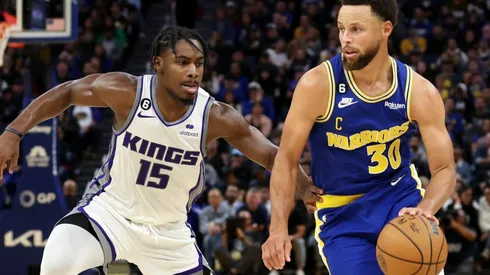 Davion Mitchell of the Sacramento Kings and Stephen Curry of the Golden State Warriors