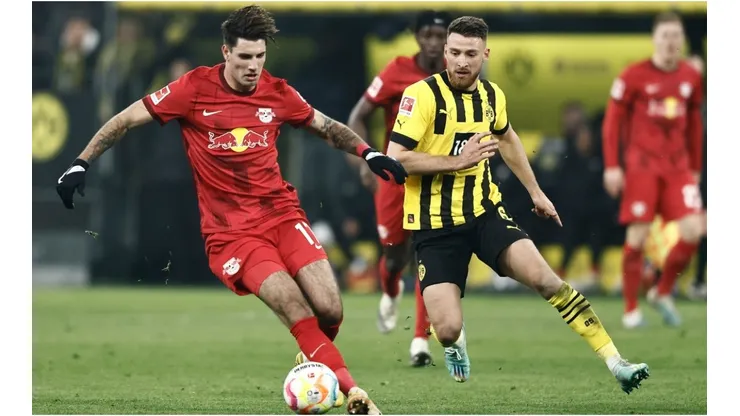 Salih Oezcan of Dortmund (R) challenges Dominik Szoboszlai of Leipzig