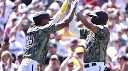 Xander Bogaerts #2 of the San Diego Padres (R) is congratulated by teammate Jose Azocar #28