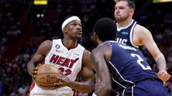 Jimmy Butler #22 of the Miami Heat drives against Kyrie Irving #2 and Luka Doncic #77 of the Dallas Mavericks