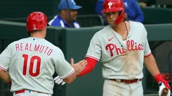 J.T. Realmuto #10 of the Philadelphia Phillies is greeted by teammate Alec Bohm.
