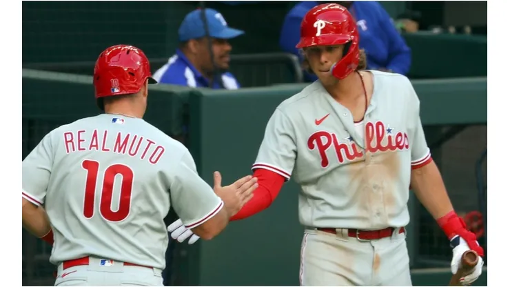 J.T. Realmuto #10 of the Philadelphia Phillies is greeted by teammate Alec Bohm.