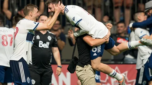 Tristan Blackmon of the Vancouver Whitecaps FC celebrates with teammate Julian Gressel