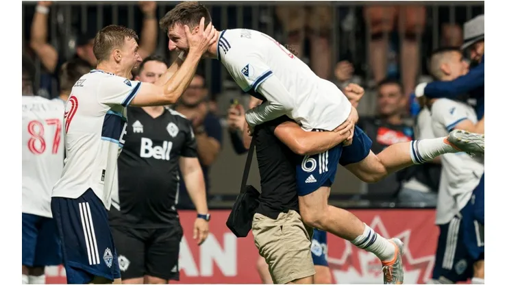 Tristan Blackmon of the Vancouver Whitecaps FC celebrates with teammate Julian Gressel