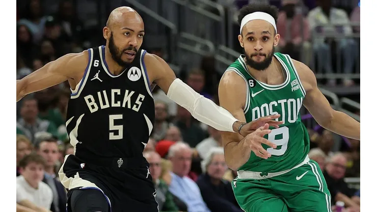 Jevon Carter of the Milwaukee Bucks and Derrick White of the Boston Celtics