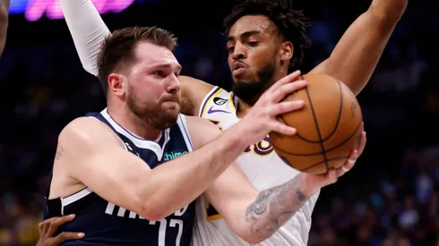 Luka Doncic of the Dallas Mavericks and Troy Brown Jr. of the Los Angeles Lakers