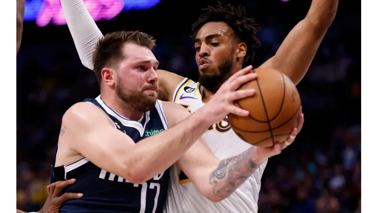 Luka Doncic of the Dallas Mavericks and Troy Brown Jr. of the Los Angeles Lakers