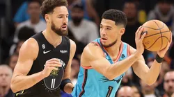 Devin Booker #1 of the Phoenix Suns handles the ball against Klay Thompson #11 of the Golden State Warriors