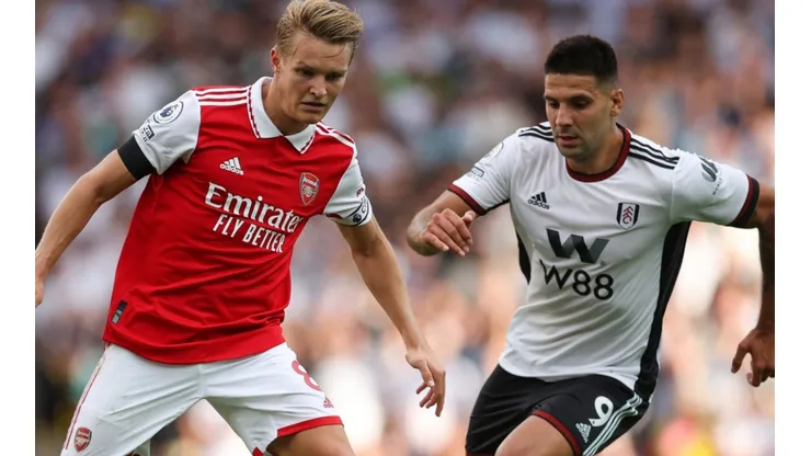 Martin Odegaard of Arsenal and Aleksandar Mitrovic of Fulham