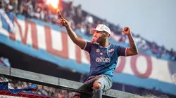 A fan with a flare wears a mask of Luis Suarez during the unveiling of the Uruguayan player Luis Suarez as the new player of Nacional at the Parque Central Stadium on July 31, 2022 in Montevideo, Uruguay.