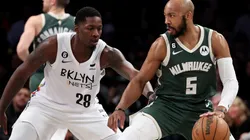 Dorian Finney-Smith of the Brooklyn Nets and Jevon Carter of the Milwaukee Bucks