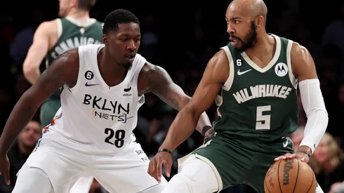 Dorian Finney-Smith of the Brooklyn Nets and Jevon Carter of the Milwaukee Bucks