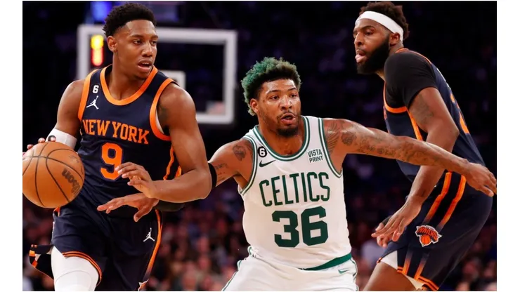 RJ Barrett #9 of the New York Knicks dribbles as Marcus Smart #36 of the Boston Celtics